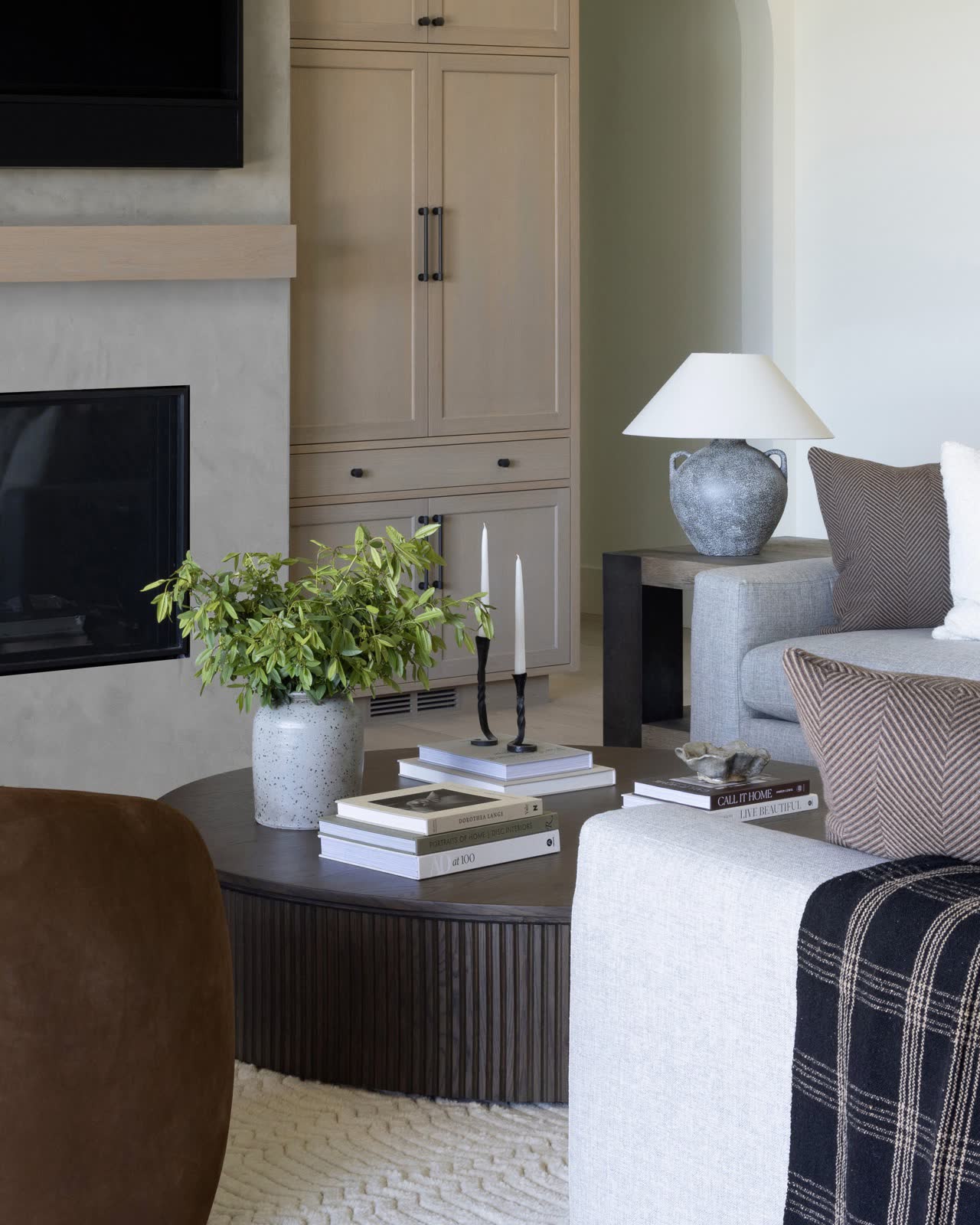 A cozy living corner with floating shelves and a fireplace.